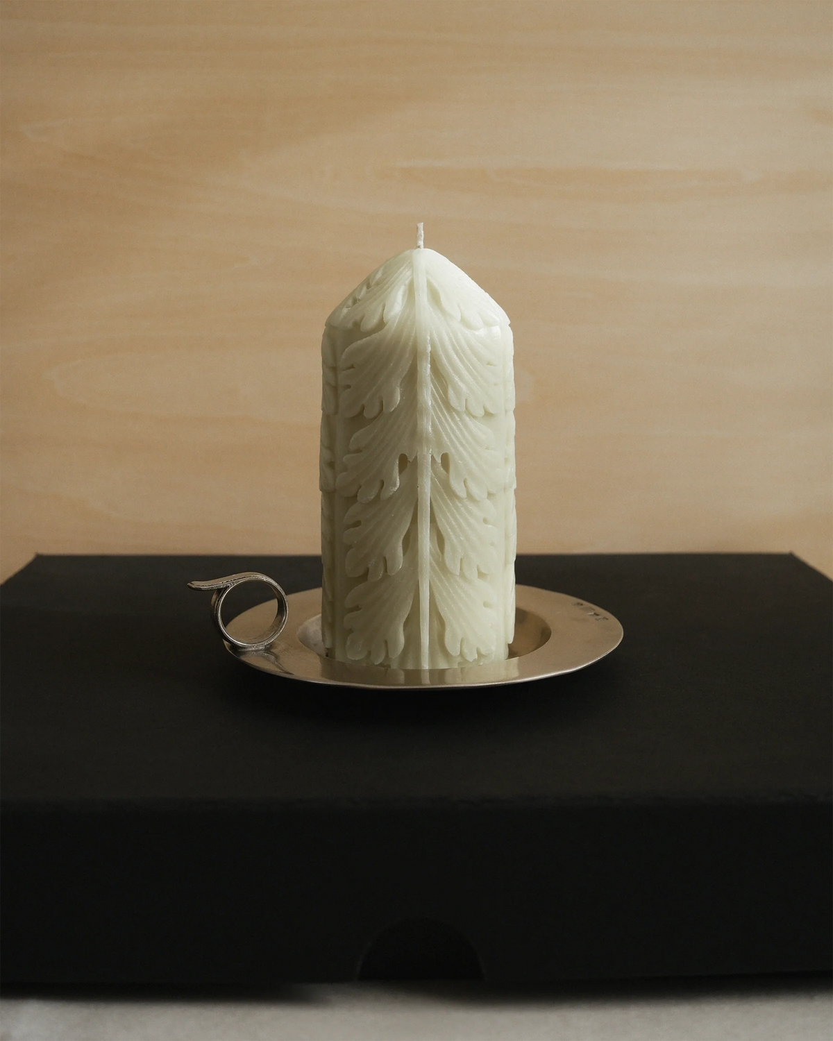 Chamber set with an Acantha Pillar Candle, decorated with acanthus leaf relief, and a pewter chamberstick.